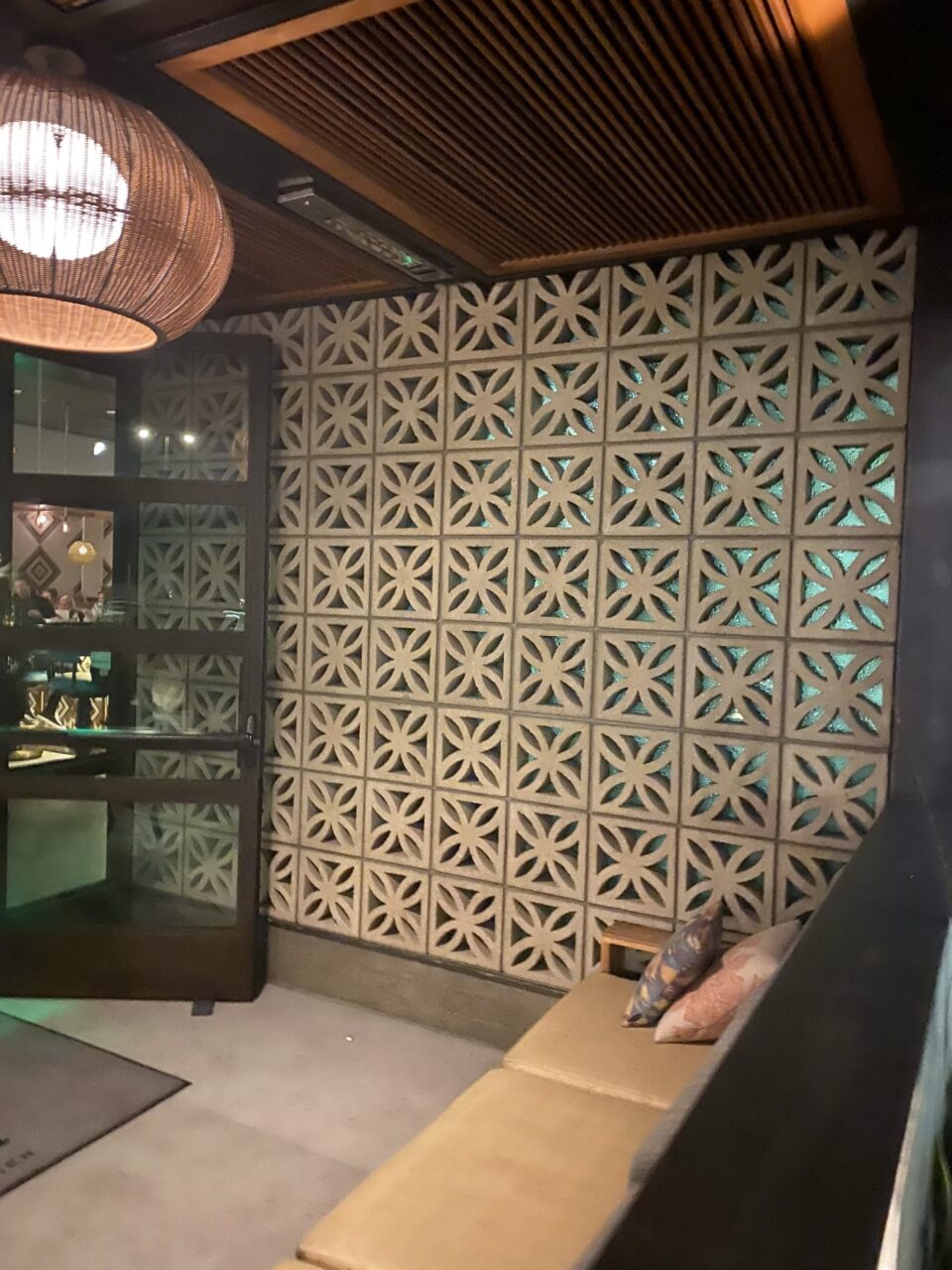 Hotel entrance front lobby with breeze block decorative wall.